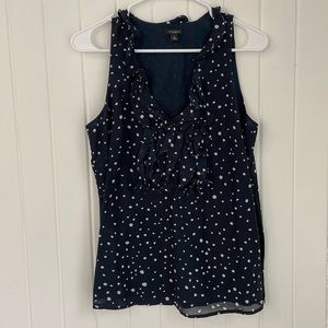Sleeveless navy and white polkadot blouse